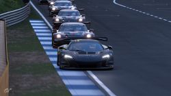 A Train of Porsches Following the McLaren